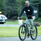 Uber CEO Dara Khosrowshahi doing the normal thing where you ride a bike and read a tablet at the same time